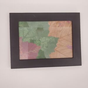 Picture frame with decorative paper leaves display